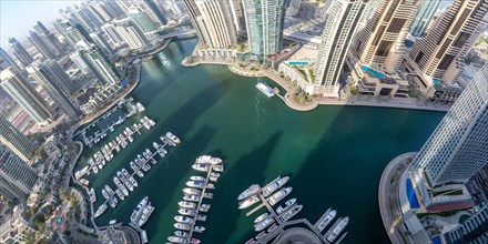Dubai Marina and Harbour luxury wealth holiday with boats yacht from above panorama in Dubai