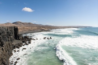 Waves in front of rocky coast