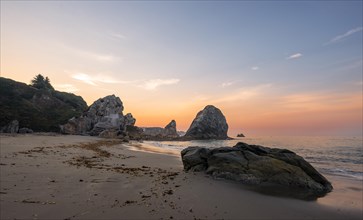 Sandy beach beach Harris Beach with rocks at sunrise