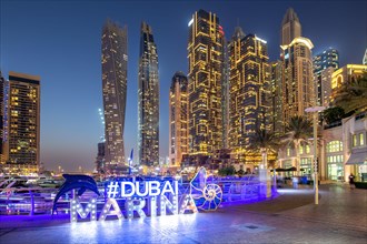 Dubai Marina Logo and Harbour Skyline Architecture Luxury Holiday in Arabia by Night in Dubai