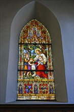 Leaded glass window from 1883 with depiction of Christ