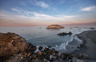 Sandy beach beach Harris Beach with rocks at sunrise