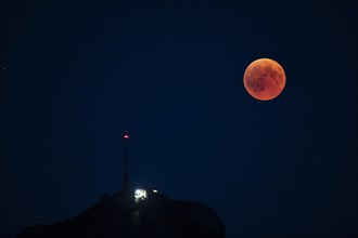 Lunar eclipse above the mountain station of Hohen Kasten