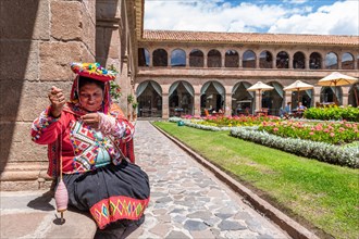 Inca woman spinning wool in the courtyard of the Belmond Hotel Monasterio
