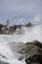 Storm Lolita whips waves against the stony shore in the background Hagnau