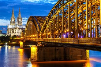 Cologne Cathedral Skyline and Hohenzollern Bridge with River Rhine in Germany at night in Cologne