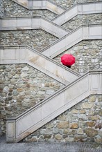 Red umbrella on the beautiful stairs to Bratislava castle