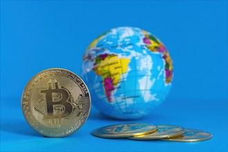 Bitcoin BTC crypto currency gold coin and Earth globe