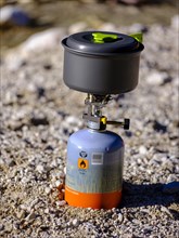Camping cooker with gas cartridge and aluminium cooking pot