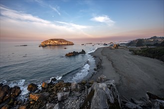 Sandy beach beach Harris Beach with rocks at sunrise