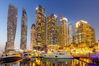 Dubai Marina and Harbour Skyline Architecture Luxury Holiday in Arabia with Boat Yacht by Night in Dubai