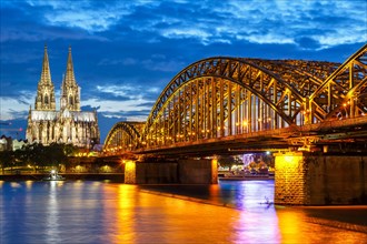 Cologne Cathedral Skyline and Hohenzollern Bridge with River Rhine in Germany at night in Cologne