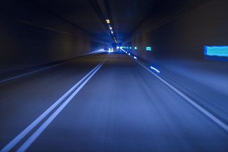 Cars Driving in Tunnel at Night