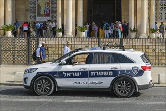 Police car in front of the Church of All Nations