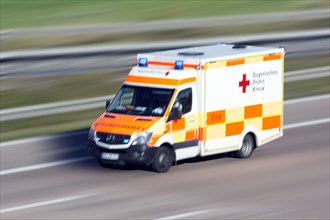 Ambulance with blue light drives on the motorway to emergency operation