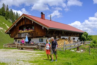 Hikers in front of the Rettenbeck Alm