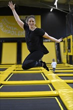 Woman at a trampoline playground