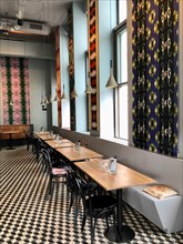 Modern furnished restaurant with different colourful patterned wallpapers