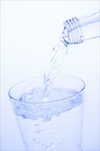 Mineral water is poured into a glass