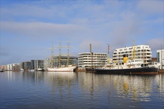 Modern buildings and traditional ships in the new harbour