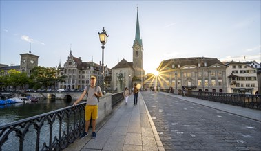 Tourist on the Muenster bridge over the river Limmat