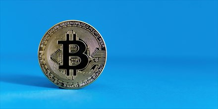 Bitcoin BTC crypto currency gold coin on blue background