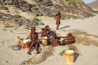 Himba women collecting water at a water hole