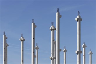 Concrete columns of an industrial hall against a blue sky