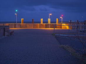 Harbour entrance with position lights in the evening at blue hour