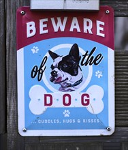 Humorous sign warning of the dog