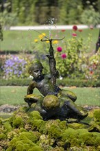 Water feature with figure of a boy in the palace garden at Schwetzingen Palace
