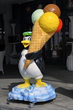 Penguin figure with ice cream cone