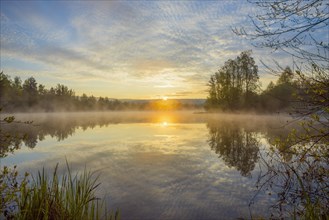 Lake with morning mist at sunrise