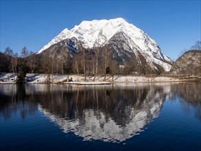 Mount Grimming reflected in the lake in winter