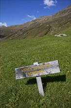 Alpine pasture Wooden sign Meadow no trespassing