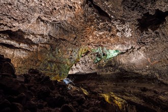 Colourfully illuminated areas of the Cueva de los Verdes