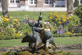Water feature with figure of a boy in the palace garden at Schwetzingen Palace
