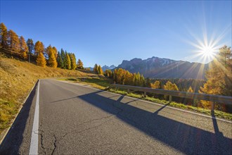 Mountain road with sun in autumn