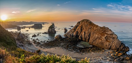 View of sea and sandy beach Harris Beach with rocks at sunrise