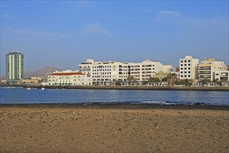 Houses on the harbour promenade with Grand Hotel Arrecife