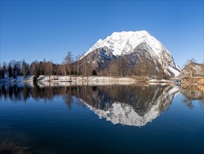 Mount Grimming reflected in the lake in winter