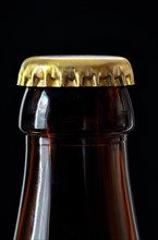 Beer bottle with gold coloured crown cork