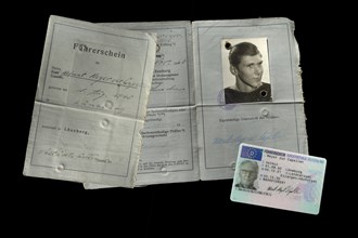Old driving licence from 1963 and a new driving licence from 2022 in cheque card format on black background