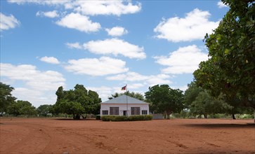 Administration building with flag in the village of Saute