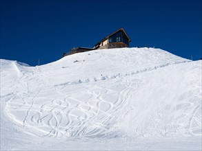 Snowy slope with traces of skiers in the snow
