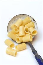 Cooked rigatoni with strainer ladle