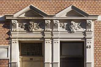 Double portal with pediment and pilaster