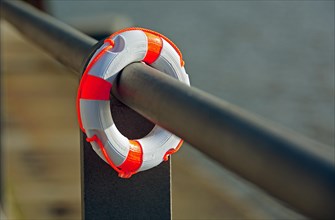 Small lifebelt hanging from a railing