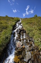 Mountain stream with waterfall in the rear Passeier Valley