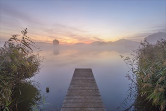Wooden Jetty with Reflective Sky in Lake at Dawn